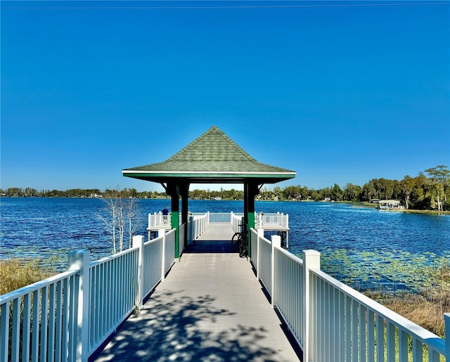 view of dock featuring a gazebo and a water view