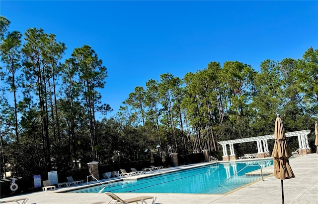 view of pool with a pergola and a patio