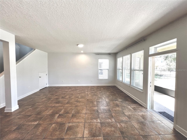 spare room with a textured ceiling