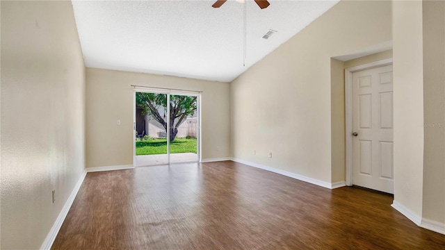 spare room with dark hardwood / wood-style floors, ceiling fan, a textured ceiling, and vaulted ceiling