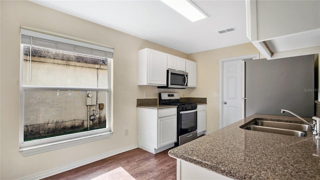 kitchen featuring dark wood-type flooring, white cabinetry, sink, and stainless steel appliances