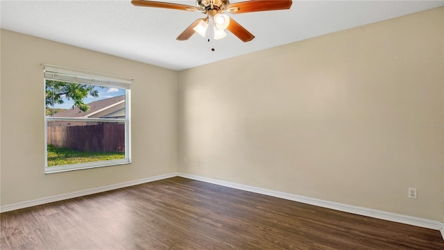 empty room with dark hardwood / wood-style flooring and ceiling fan