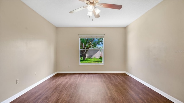 spare room featuring ceiling fan and dark wood-type flooring