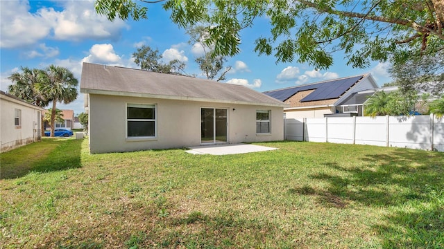 back of property featuring a patio and a lawn