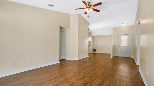 unfurnished living room featuring dark hardwood / wood-style flooring, vaulted ceiling, and ceiling fan