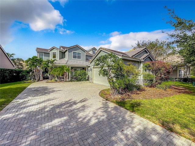 view of front of house featuring a front yard and a garage