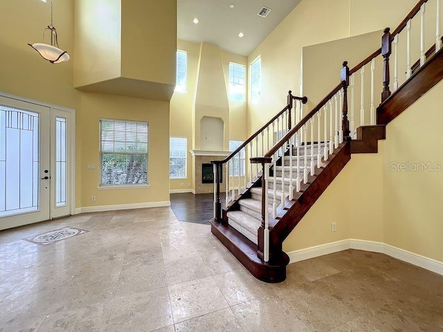 foyer entrance with a towering ceiling and a healthy amount of sunlight