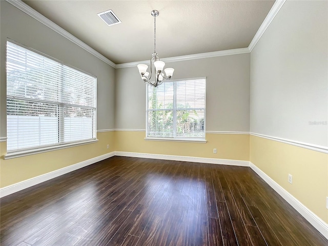 spare room with a notable chandelier, dark hardwood / wood-style flooring, and ornamental molding