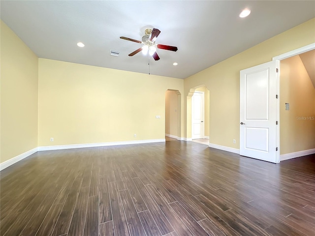 empty room with dark hardwood / wood-style floors and ceiling fan