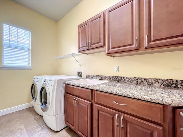 washroom with washing machine and dryer, sink, and cabinets