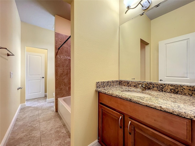 bathroom featuring tile patterned floors, vanity, and tiled shower / bath