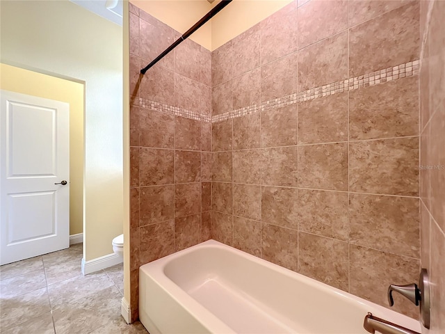 bathroom with tiled shower / bath combo and toilet