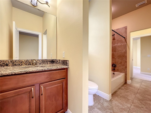 full bathroom featuring tiled shower / bath, tile patterned flooring, vanity, and toilet