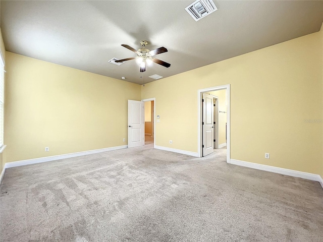 carpeted spare room featuring ceiling fan