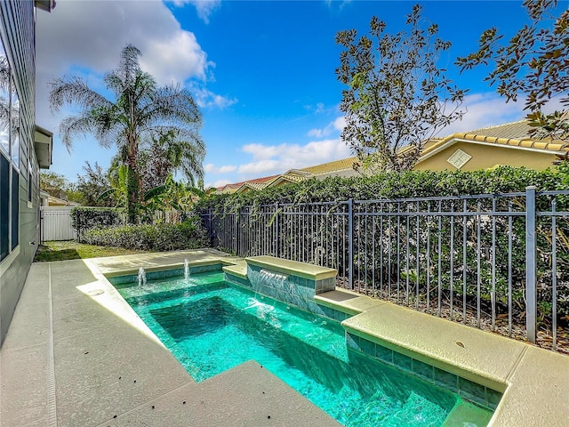 view of pool with pool water feature and an in ground hot tub