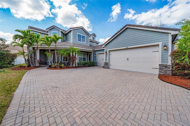 view of front of house featuring decorative driveway and a garage