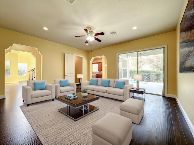7508 Lake Albert Dr, Windermere, FL 34786 - living area with wood finished floors, visible vents, baseboards, and arched walkways