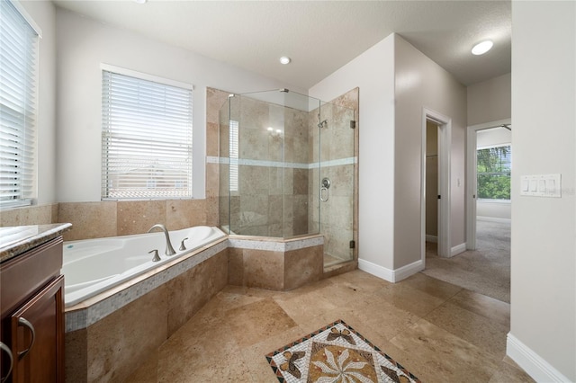 7508 Lake Albert Dr, Windermere, FL 34786 - full bath featuring a garden tub, vanity, a stall shower, and baseboards