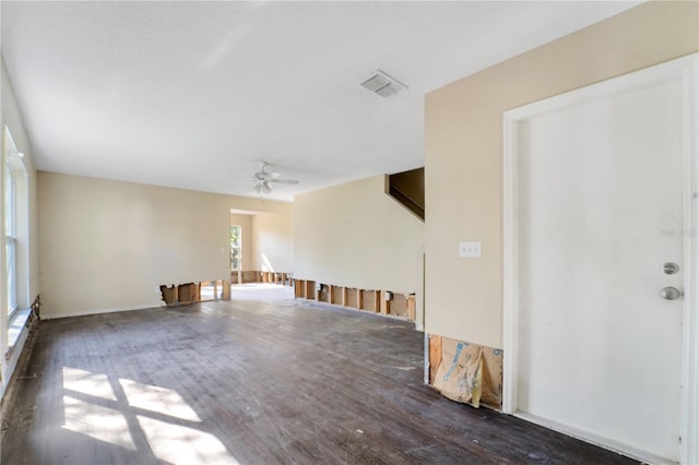 unfurnished room with ceiling fan and dark wood-type flooring