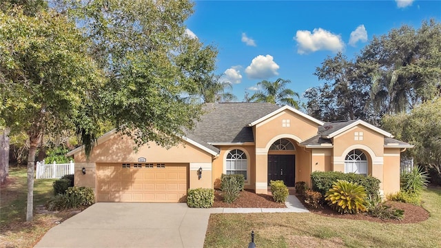 ranch-style house featuring a front yard and a garage