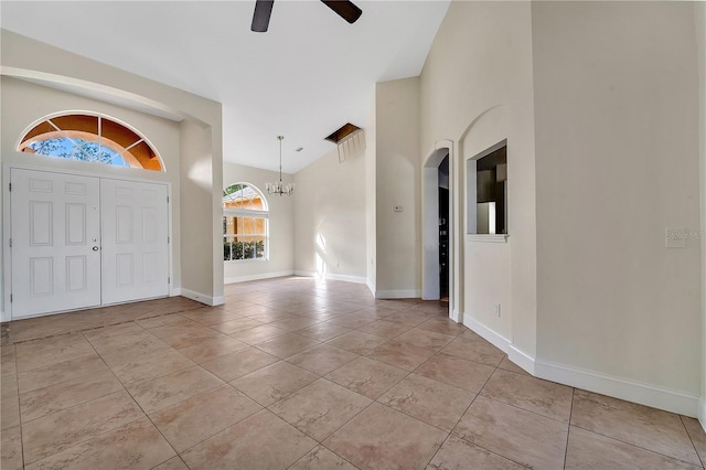 tiled entryway with ceiling fan with notable chandelier