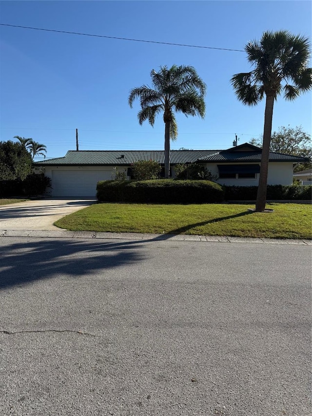 view of front of house with a front yard and a garage