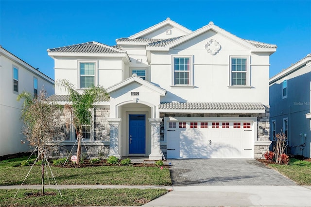 view of front of property with a garage and a front lawn