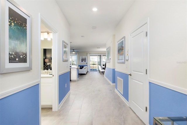 hall with light tile patterned floors