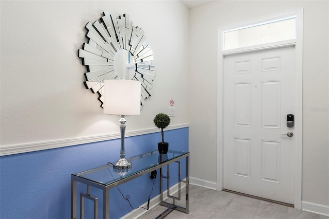 foyer entrance featuring baseboards