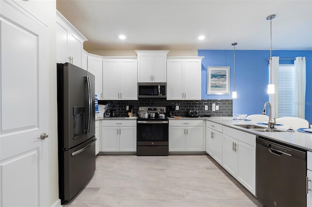 kitchen with white cabinets, pendant lighting, stainless steel appliances, and sink