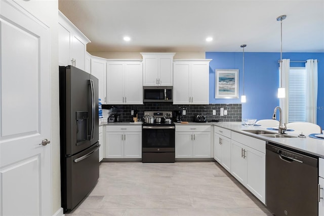 kitchen featuring stainless steel appliances, a sink, decorative backsplash, light countertops, and recessed lighting