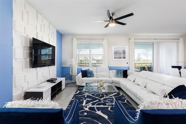 living room with ceiling fan, wood-type flooring, and a wealth of natural light