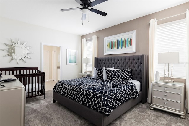 carpeted bedroom featuring ensuite bath and ceiling fan