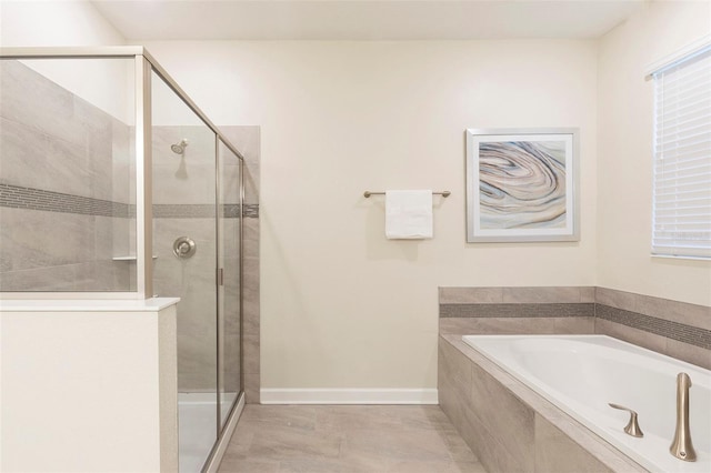 bathroom featuring shower with separate bathtub