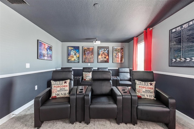 cinema room with carpet flooring and a textured ceiling