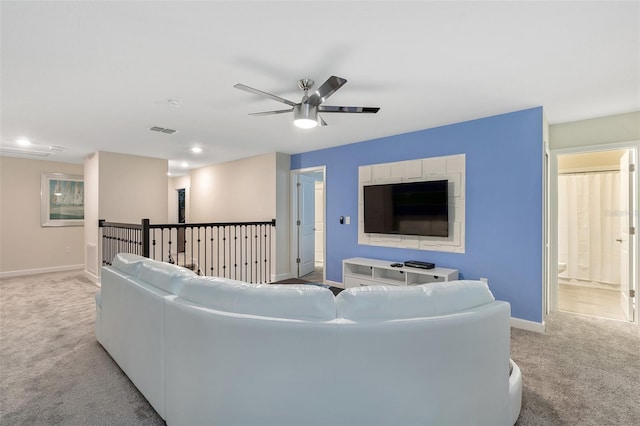 living room featuring carpet, baseboards, a ceiling fan, and recessed lighting