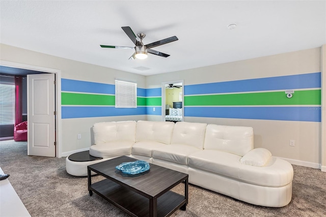 living room with carpet floors, a ceiling fan, and baseboards