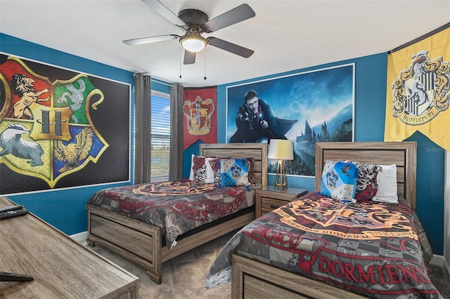 carpeted bedroom with a ceiling fan and baseboards