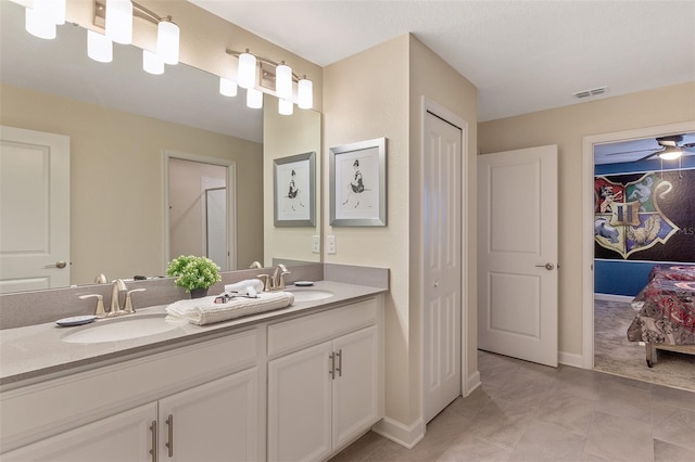 bathroom featuring ceiling fan and vanity