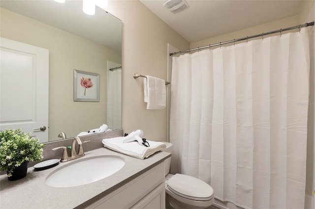 full bathroom with toilet and vanity