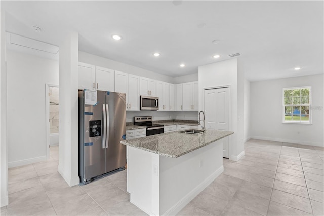 kitchen with white cabinetry, light stone counters, sink, and stainless steel appliances