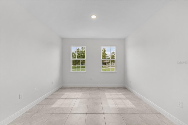 unfurnished room featuring light tile patterned floors