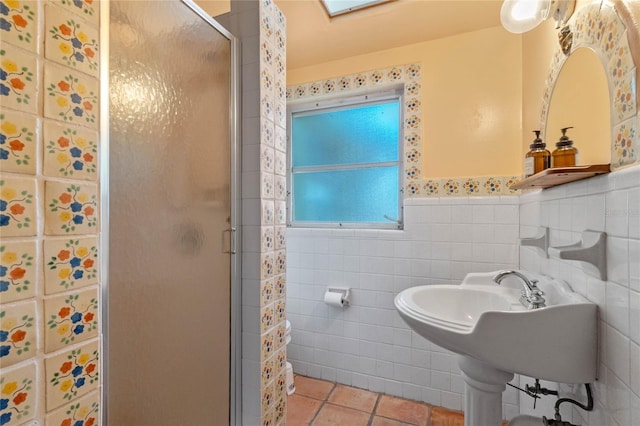 bathroom with walk in shower, tile patterned floors, and tile walls