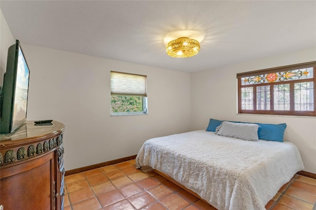 tiled bedroom featuring multiple windows