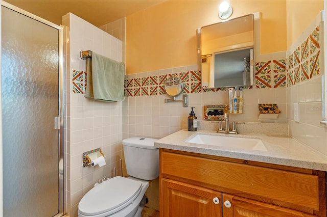 bathroom featuring toilet, an enclosed shower, tile walls, and vanity