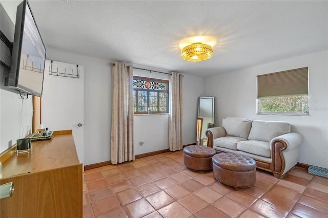 living room with light tile patterned floors and a textured ceiling