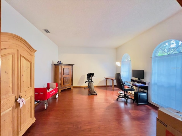 office area featuring visible vents, baseboards, and dark wood-style flooring