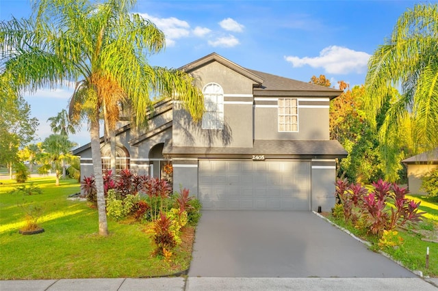 view of front of home featuring a front lawn and a garage