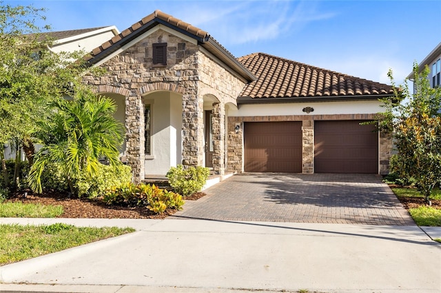 mediterranean / spanish-style home featuring a garage