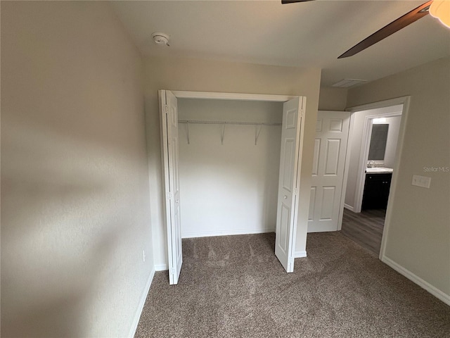 unfurnished bedroom with carpet floors, baseboards, and a closet